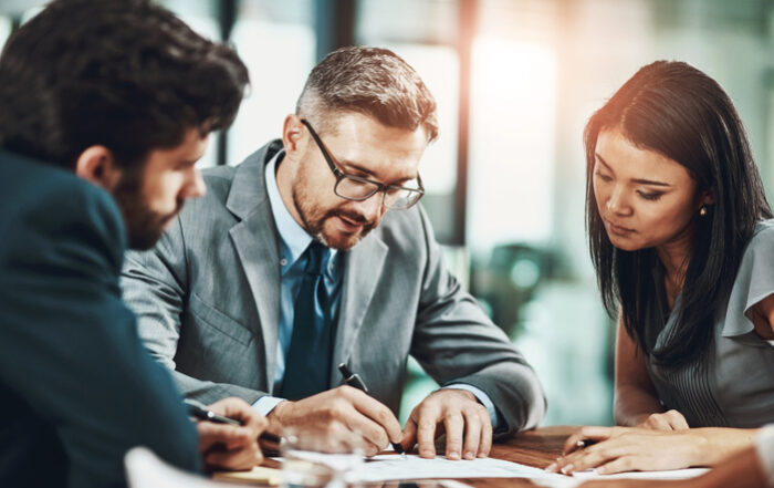 Business people and writing of plan report and paperwork for speech of politician and government Documents reading and ceo with employees brainstorming and publicist in boardroom for ideasQuick Reliable Printing (QRP)