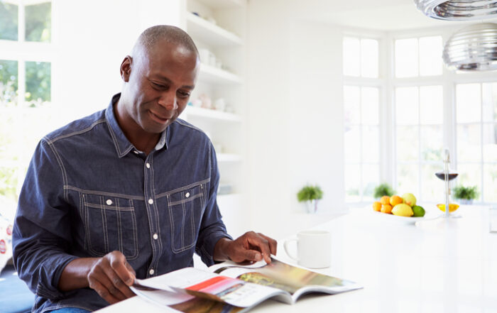African American Man Reading Magazine At HomeQuick Reliable Printing (QRP)