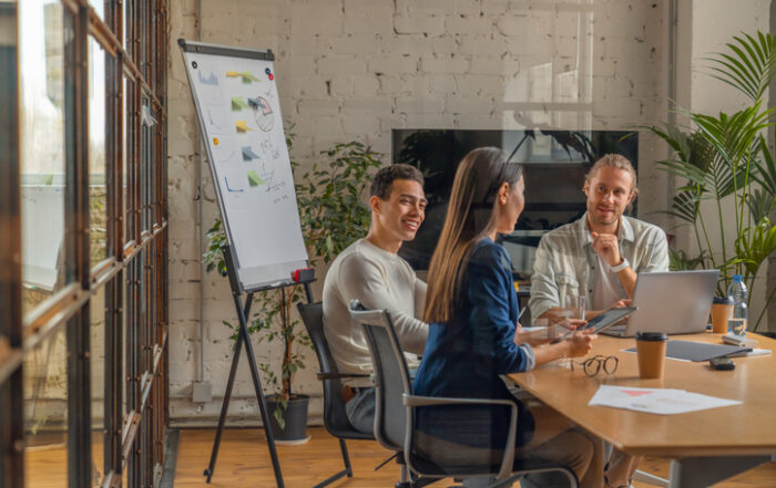 Indoor shot of creative team discussing ideas in business meeting Multi ethnic business people working together on new project in officeQuick Reliable Printing (QRP)