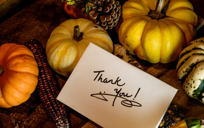 Happy Thanksgiving Card with words Thank you on handwritten card Autumn harvest on rustic wood backgroundQuick Reliable Printing (QRP)