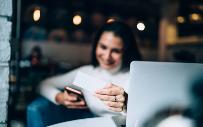 Selective focus on female hands holding business card and smartphone and dialing number for making smartphone communication woman searching information about contact texting sms with detailsQuick Reliable Printing (QRP)