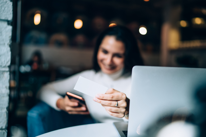 Selective focus on female hands holding business card and smartphone and dialing number for making smartphone communication woman searching information about contact texting sms with detailsQuick Reliable Printing (QRP)