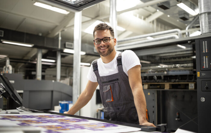 Portrait of worker at control room checking print quality at printing houseQuick Reliable Printing (QRP)