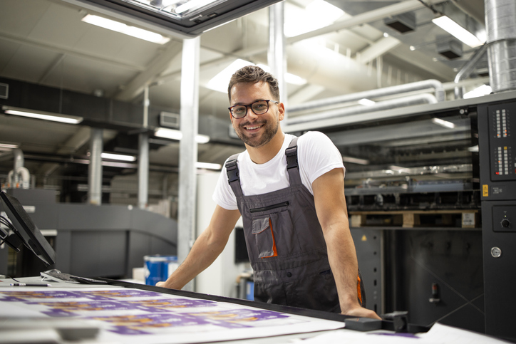Portrait of worker at control room checking print quality at printing houseQuick Reliable Printing (QRP)