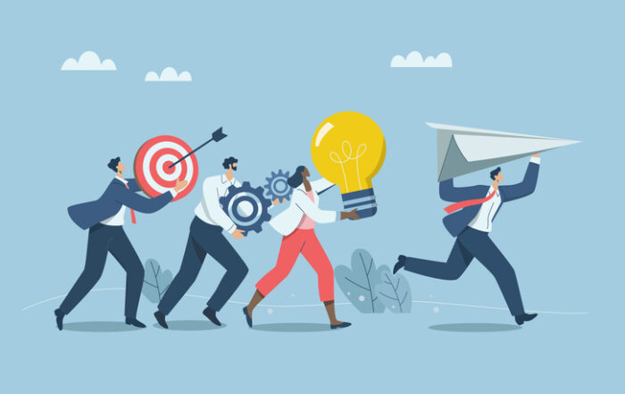 Working as team with creative thinking solving problems in organizations Launching new project or new product Group of business people running holding paper airplanes light bulbs gears targetsQuick Reliable Printing (QRP)