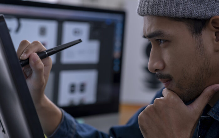 Young Asian male designer drawing on digital tabletQuick Reliable Printing (QRP)