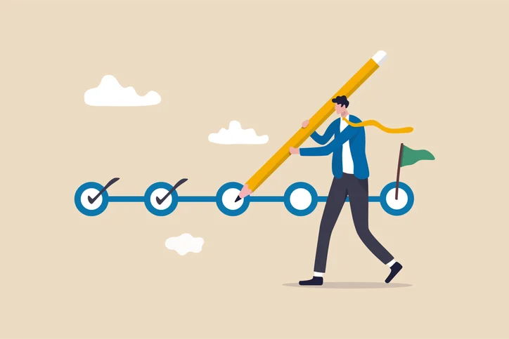 Project tracking goal tracker task completion or checklist to remind project progress concept businessman project manager holding big pencil to check completed tasks in project management timeline | Quick Reliable Printing (QRP) Person in a blue suit uses a giant pencil to connect a chain of circular checkpoints toward a final flag, symbolizing progress toward a goal.Quick Reliable Printing (QRP)